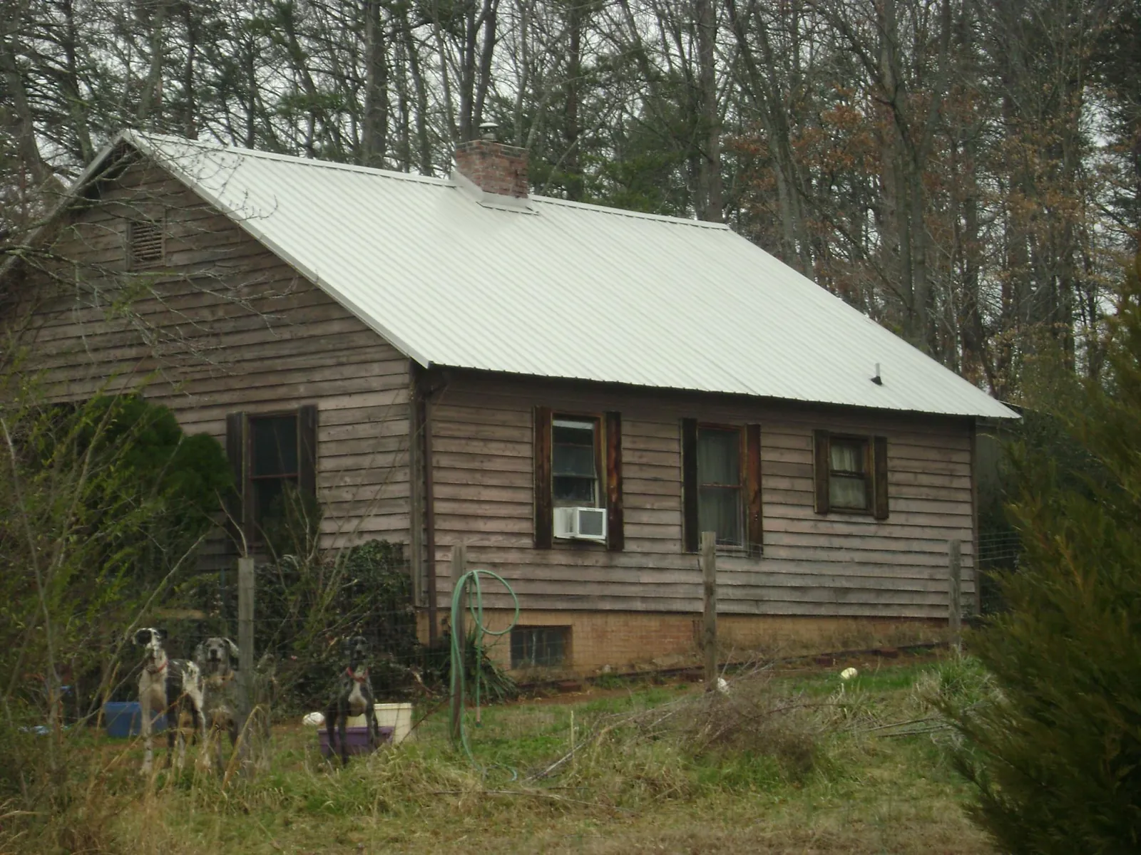 White metal roof on an old wood sided farmhouse, from a Metal Roof Installation job in Ouaquaga